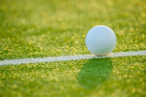 White dimple hockey ball on astro turf