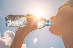 Young woman drinking bottle of water