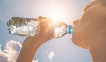 Young woman drinking bottle of water